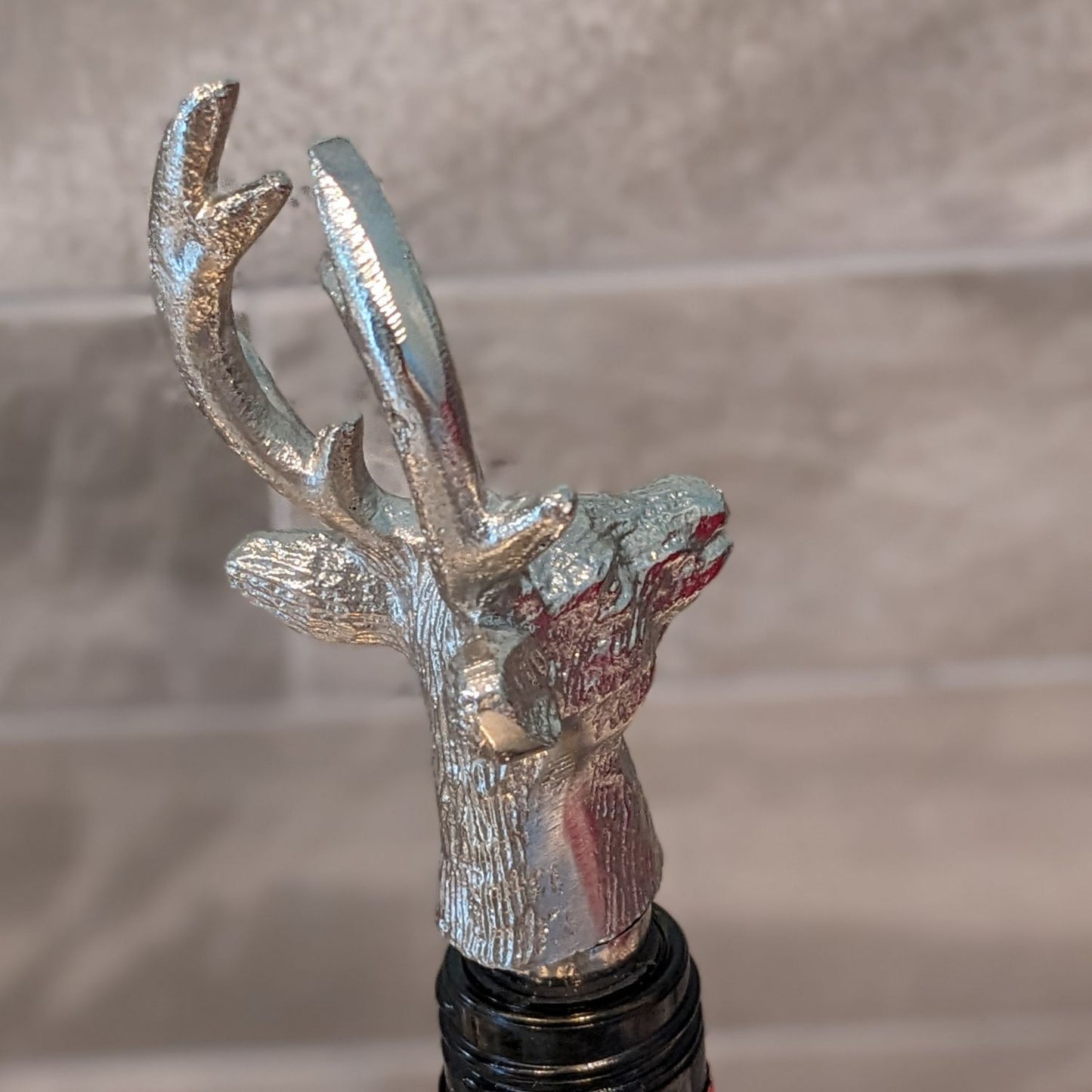 Silver stag bottle stopper.