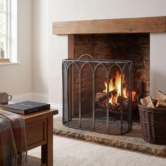 Antique Pewter & Black Firescreen with Top Handle & Gothic Arch Design – Metal Mesh Fireplace Fire Guard 65x55x21cm styled on a stone hearth with wood mantel and traditional fireplace | Click Style