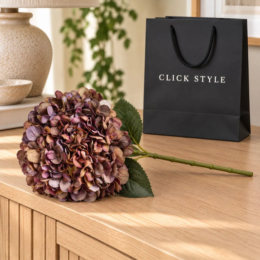 Artificial Antique Mauve & Copper Hydrangea Stem with Burgundy Petals & Realistic Green Leaves – Lifelike Faux Brown Hydrangea Flower 42x18x18cm – Single Stem Displayed on Pale Oak Sideboard with Black Branded Gift Bag | Click Style