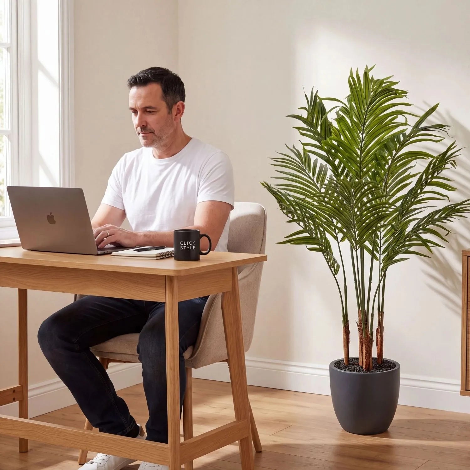 Artificial Areca Palm Plant with Dark Grey Pot – Tall Realistic Indoor Faux Palm 120x80x80cm styled in a contemporary home office beside Damian working at a desk | Click Style