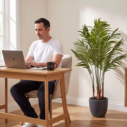Artificial Areca Palm Plant with Dark Grey Pot – Tall Realistic Indoor Faux Palm 120x80x80cm styled in a contemporary home office beside Damian working at a desk | Click Style