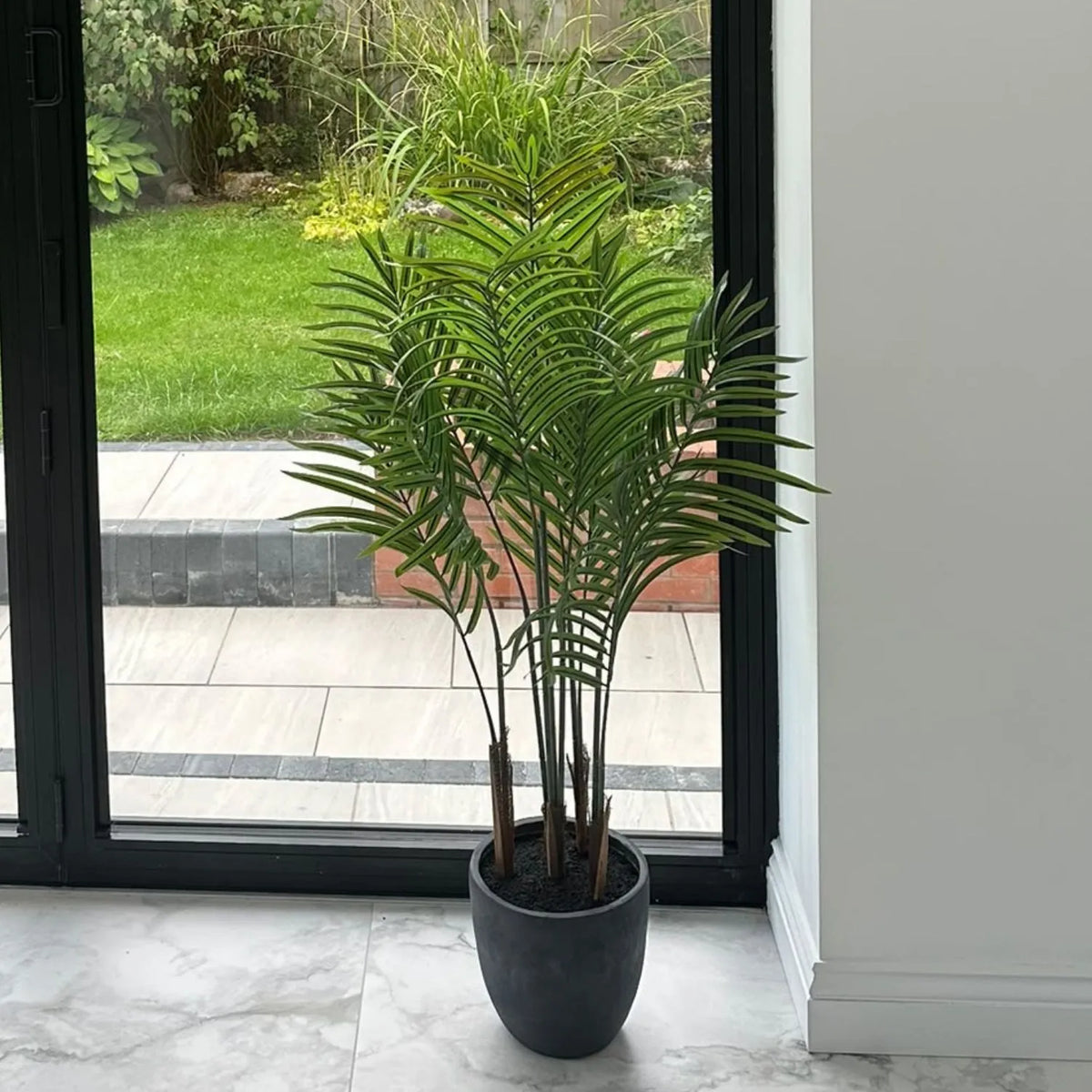Artificial Areca Palm Plant with Dark Grey Pot Styled Beside Window in Customer Home | Click Style
