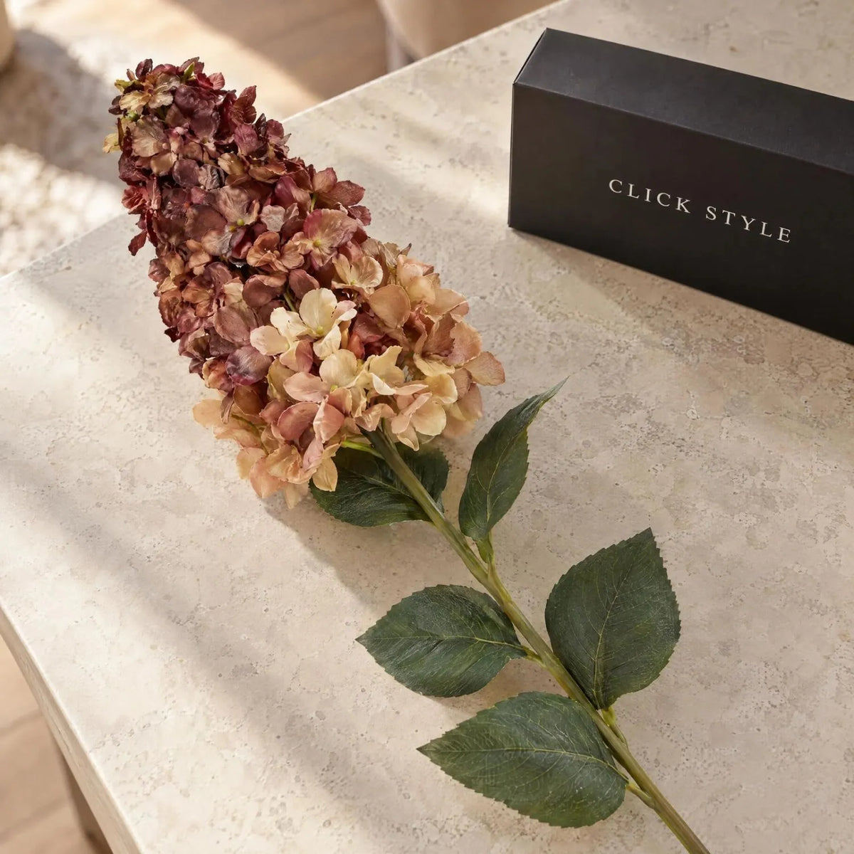 Artificial Burgundy & Peach Long Stem Spear Hydrangea with Realistic Green Leaves – Tall Faux Hydrangea Flower 88cm showing detailed burgundy, peach and cream florets with green foliage on a limestone-effect tabletop | Click Style