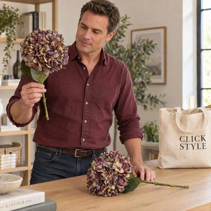 Artificial Burgundy & Plum Hydrangea Stem with Realistic Green Leaves – Lifelike Faux Purple Hydrangea Flower 42x18x18cm – Man in Burgundy Shirt Examining Single Faux Hydrangea Stem Beside Additional Flower on Oak Worktop | Click Style