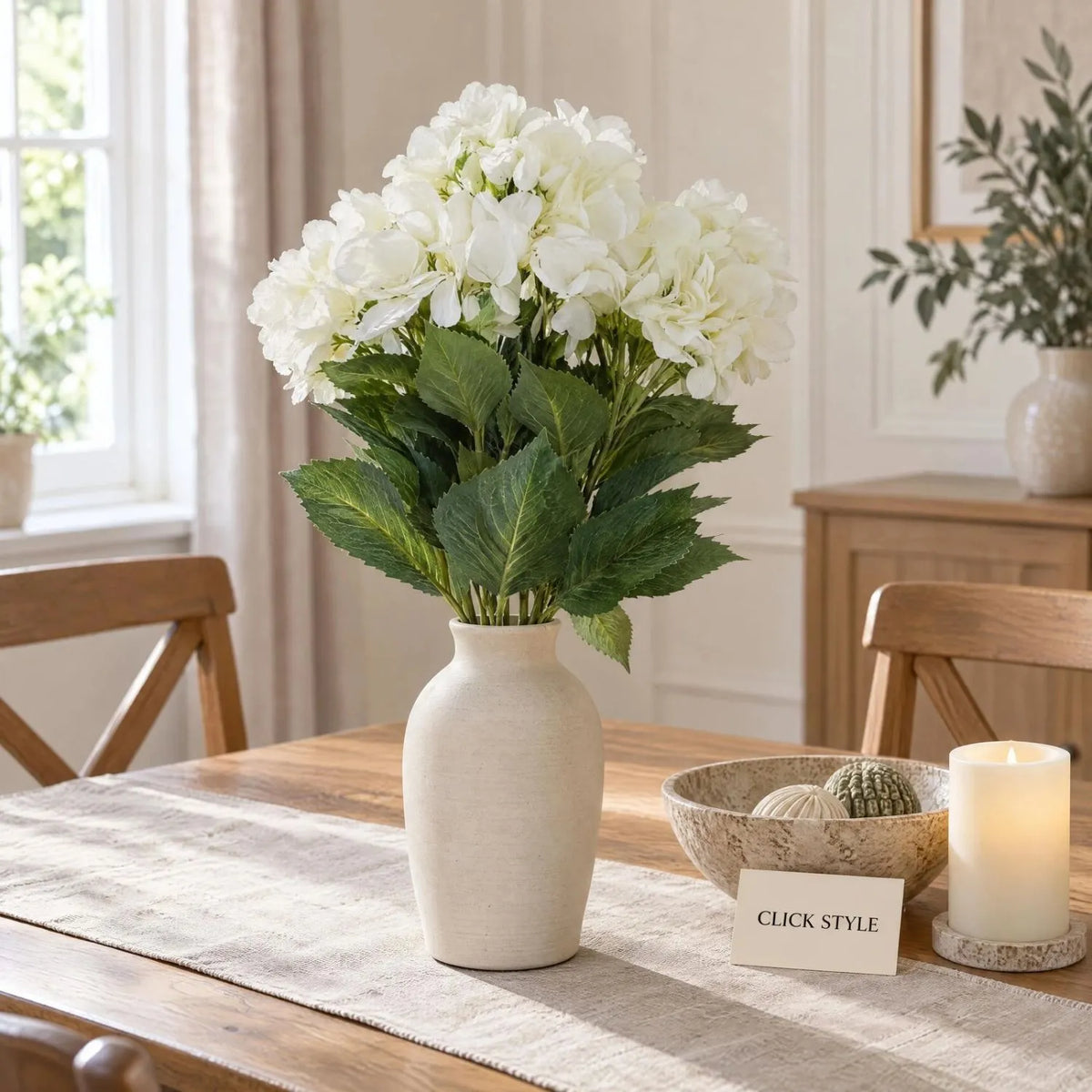 Artificial Creamy White Multi-Bloom Hydrangea Bouquet Stem with Realistic Green Foliage – Lifelike Faux Cream Hydrangea Arrangement 54x34x34cm Displayed in Matt Ivory Ceramic Vase on Natural Oak Console Table | Click Style