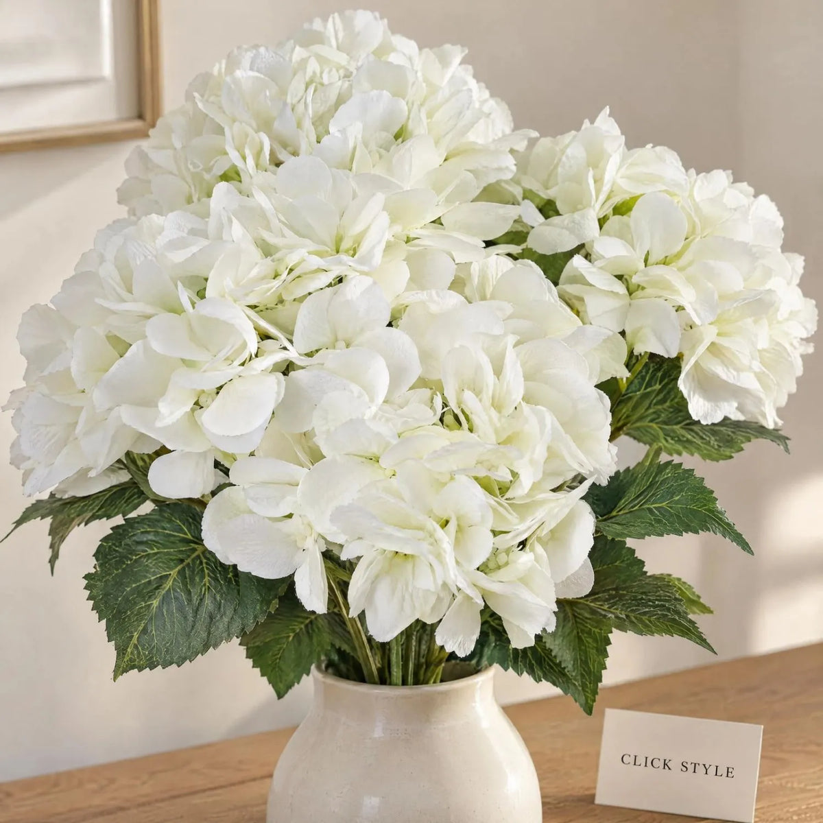 Artificial Creamy White Multi-Bloom Hydrangea Bouquet Stem with Realistic Green Foliage – Lifelike Faux Cream Hydrangea Arrangement 54x34x34cm Close-Up Showing Detailed Creamy White Petals Flower Heads and Veined Green Leaves | Click Style