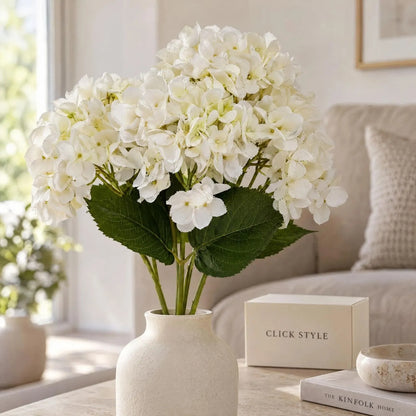Artificial Creamy White Multi-Bloom Hydrangea Stem with Realistic Green Leaves – Lifelike Faux White Hydrangea Flower 47x23x23cm – Creamy white flower clusters and dark green foliage styled in an ivory ceramic vase | Click Style