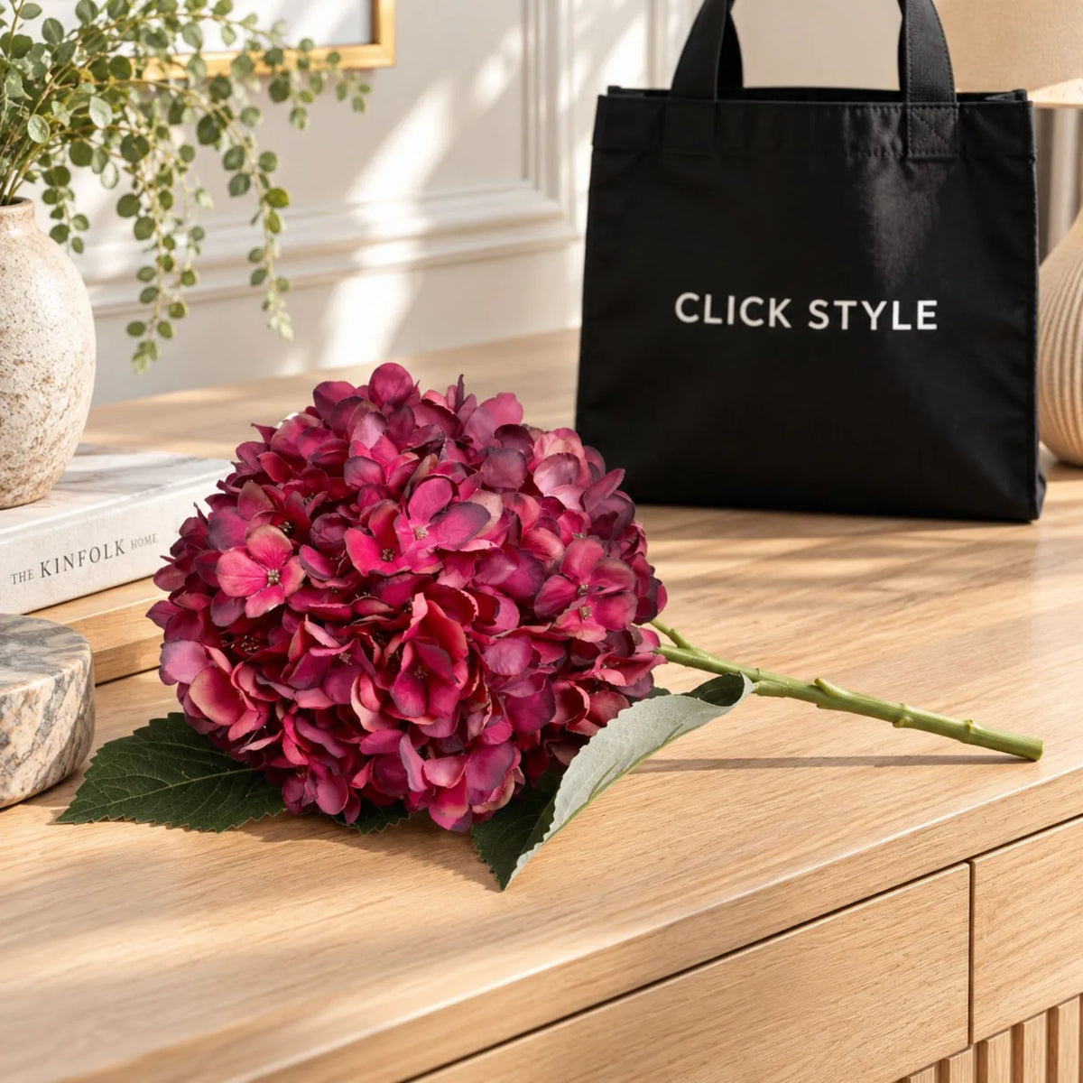 Artificial Deep Ruby Red & Burgundy Hydrangea Stem with Realistic Green Leaves – Lifelike Faux Red Hydrangea Flower 42x18x18cm – Single Artificial Hydrangea Stem Displayed on a Pale Oak Sideboard with Black CLICK STYLE Branded Tote Bag | Click Style