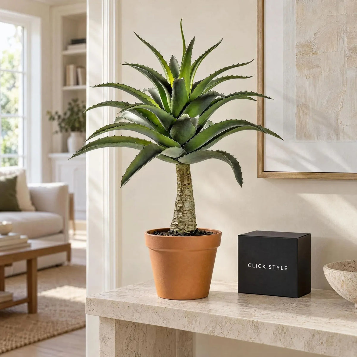 Artificial Green Agave Succulent Plant with Spiky Leaves & Textured Trunk in Terracotta Coloured Pot – Realistic Potted Faux Desert Plant 57x43x43cm displayed on a limestone console table in a contemporary neutral living room beside a black CLICK STYLE branded box | Click Style