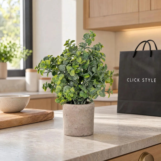 Artificial Green Eucalyptus Plant with Realistic Rounded Leaves in Rustic Stone-Effect Pot – Small Faux Potted Eucalyptus 23x19x19cm displayed on a pale stone kitchen worktop beside a ceramic bowl and black shopping bag with white CLICK STYLE branding | Click Style