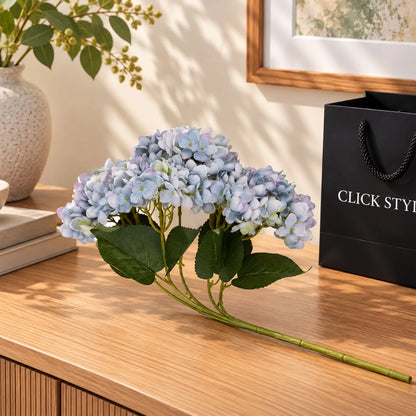 Artificial Multi-Tonal Blue Hydrangea Bouquet Stem with Five Flower Heads & Realistic Green Leaves – Faux Blue Hydrangea Flower 47x23x23cm – Single Bouquet Stem Displayed on Oak Console Table | Click Style
