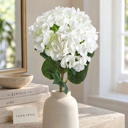 Artificial Pure White Long Stem Hydrangea with Full Rounded Flower Head & Realistic Green Leaves – Lifelike White Faux Hydrangea Flower 70cm – Close-Up of White Hydrangea Bloom with Textured Green Foliage in a Cream Ceramic Vase | Click Style