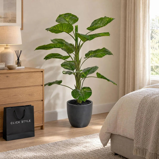 Artificial Tall Green Elephant Ear Plant with Large Variegated Leaves in Dark Grey Pot – Realistic Faux Tropical Potted Plant 120x80x80cm displayed beside a natural oak chest of drawers in a contemporary neutral bedroom with black CLICK STYLE shopping bag | Click Style