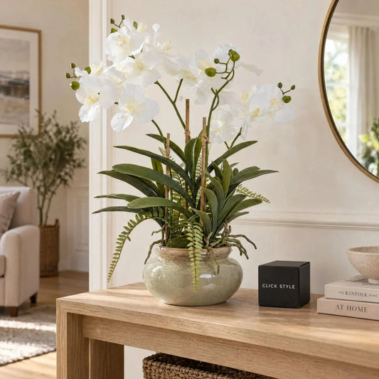 Artificial White Orchid Plant with Fern Foliage & Aerial Roots in Sage Green Glazed Ceramic Pot – Realistic Potted Faux Orchid Arrangement 68x75x56cm displayed on a natural oak console table in a contemporary neutral living room beside a black CLICK STYLE branded box | Click Style
