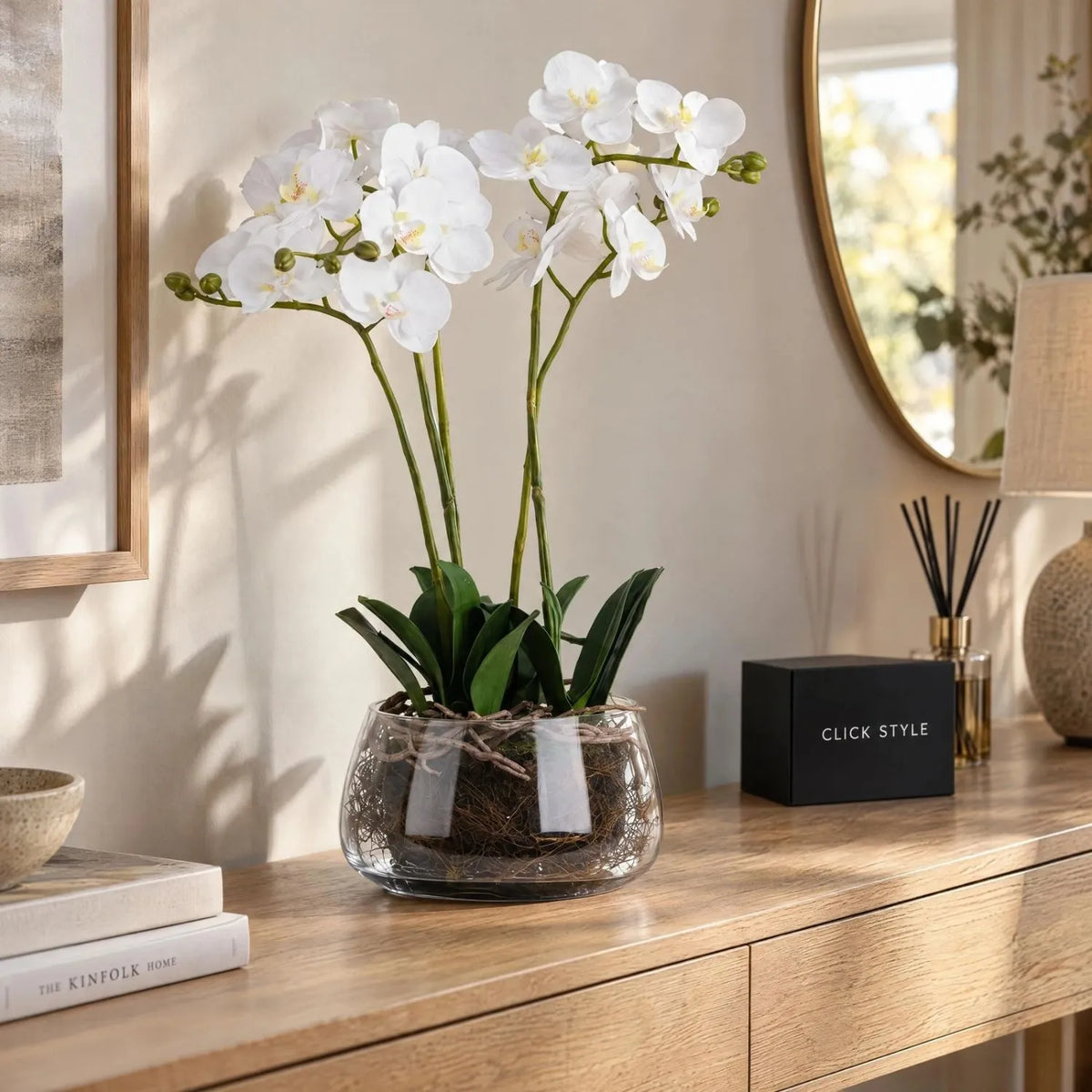 Artificial White Orchid with Realistic Exposed Roots & Dark Green Leaves in Clear Glass Bowl – Lifelike Potted Faux Orchid Plant Arrangement 61x21x21cm styled on a natural oak console table | Click Style