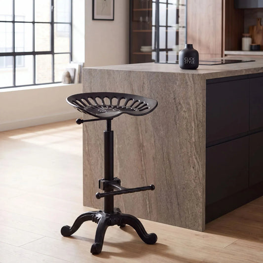 Black Industrial Style Heavy Duty Metal Adjustable Bar Stool with Tractor Seat & Footrest styled beside a modern kitchen island 86x37x37cm | Click Style