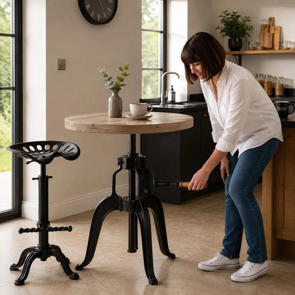 Black Industrial Style Heavy Duty Metal Adjustable Bar Table with Round Wood Top as Woman Winds Crank Handle in Modern Kitchen | Click Style