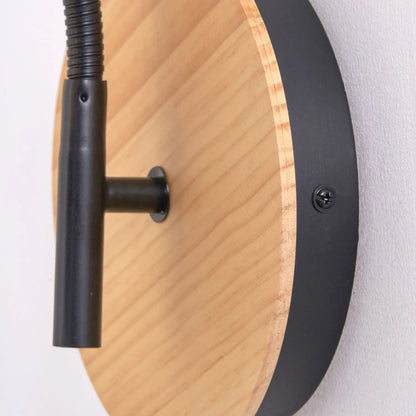 Black metal wall light with adjustable tapered linen shade and natural wood plate – modern bedside reading light | Click Style