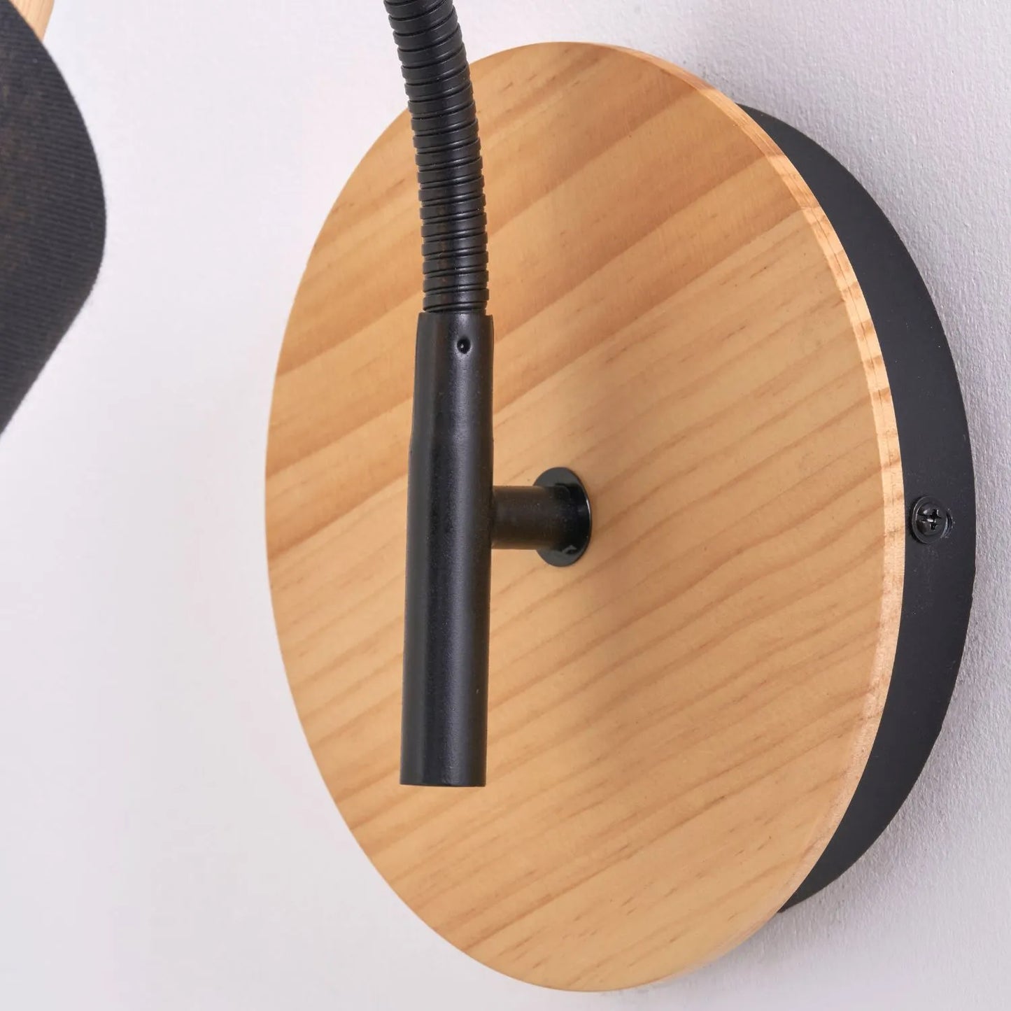 Black metal wall light with adjustable tapered linen shade and natural wood plate – modern bedside reading light | Click Style