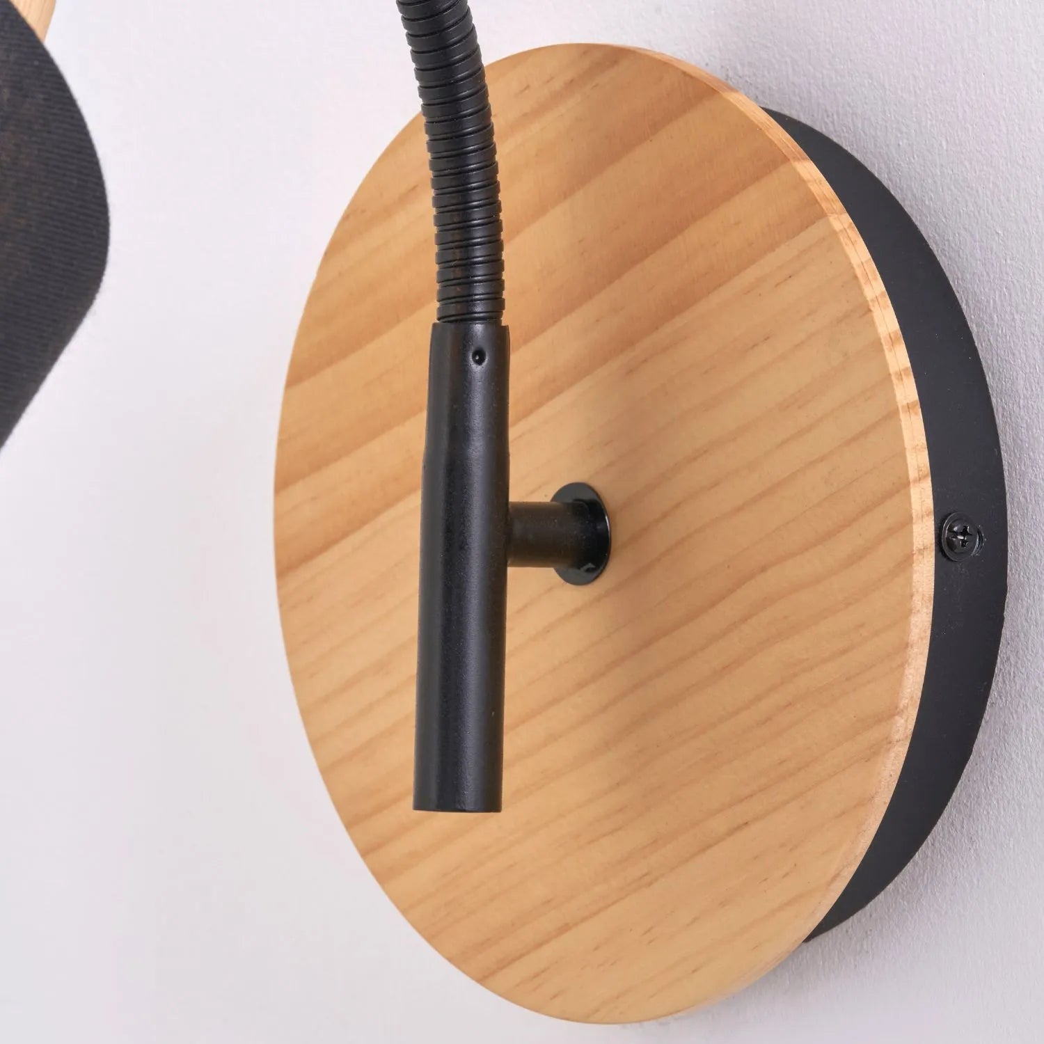 Black metal wall light with adjustable tapered linen shade and natural wood plate – modern bedside reading light | Click Style