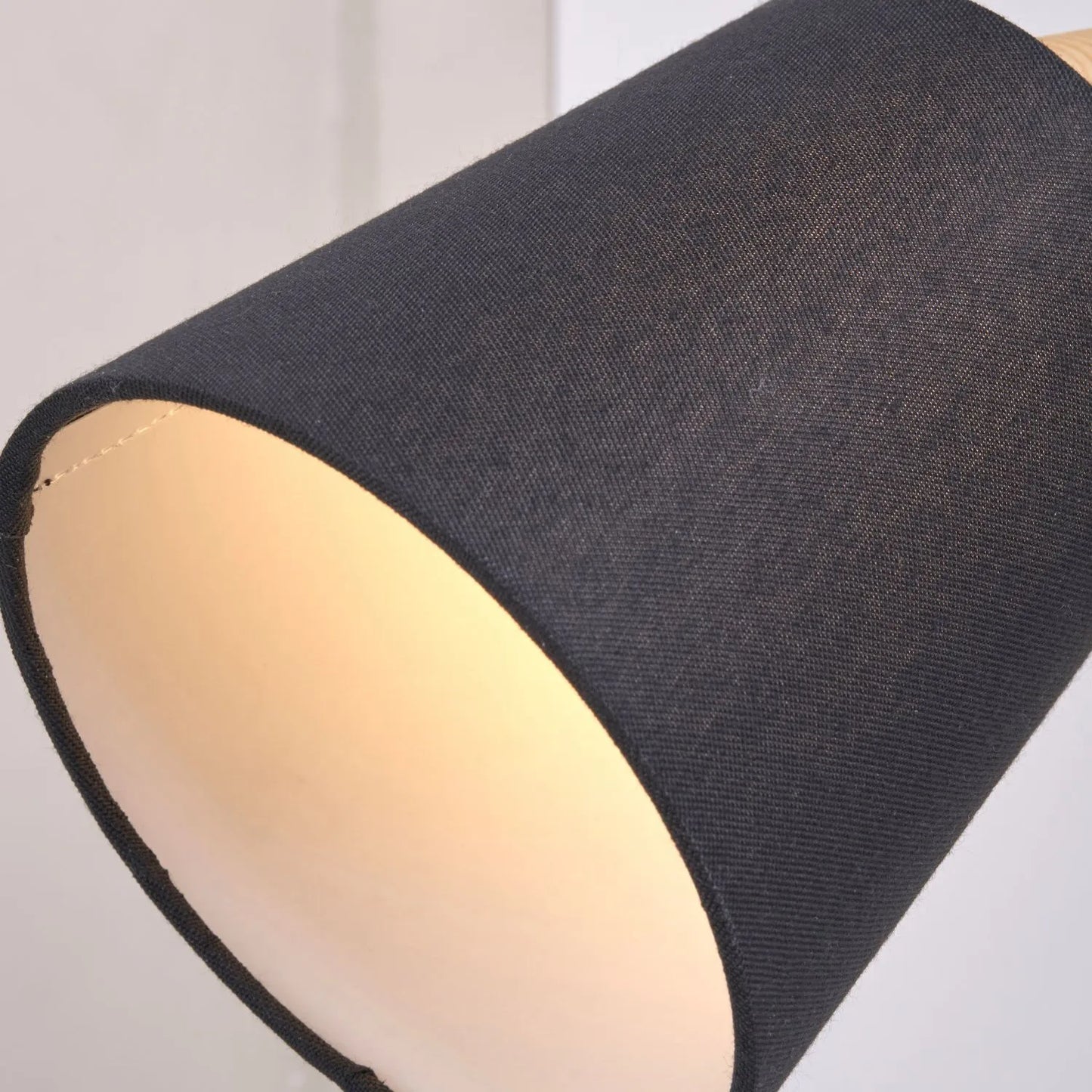 Black metal wall light with adjustable tapered linen shade and natural wood plate – modern bedside reading light | Click Style