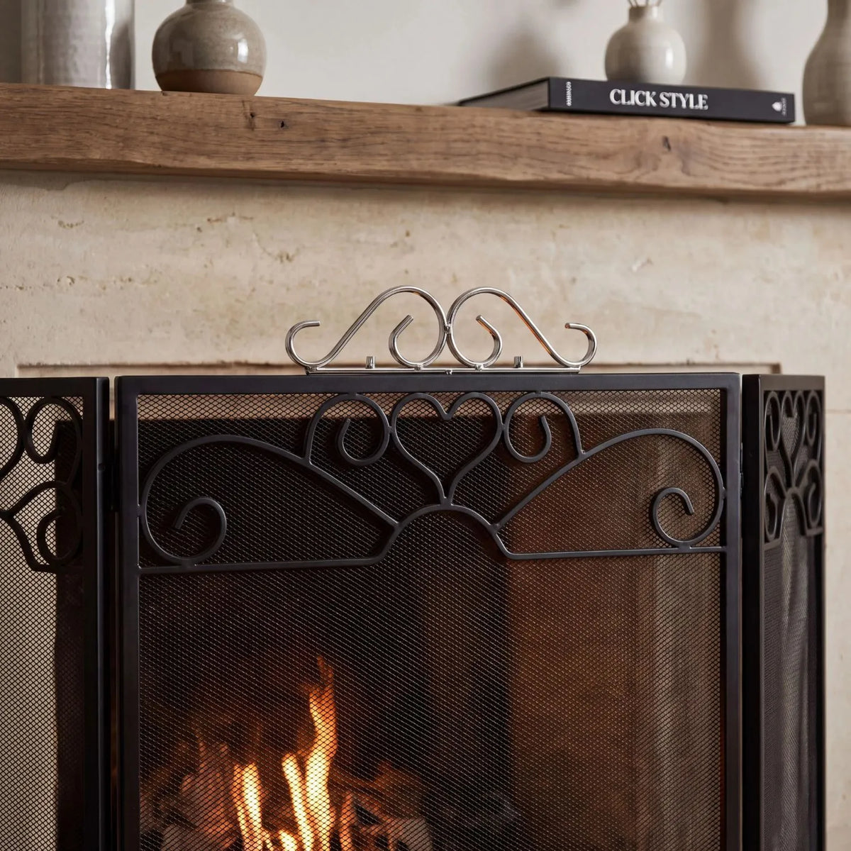 Black & Chrome 3 Panel Folding Firescreen with Decorative Scrollwork – Metal Fireplace Fire Guard 65x98x23cm close-up showing chrome top, black scrollwork and mesh | Click Style