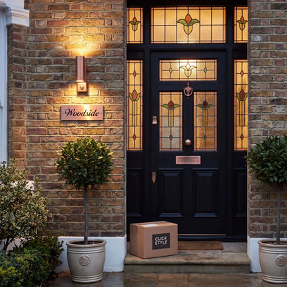 Brushed Copper Outdoor Up & Down PIR Motion Sensor Wall Light Illuminating an Exterior Wall with Dual Up and Down Light Beams | Click Style
