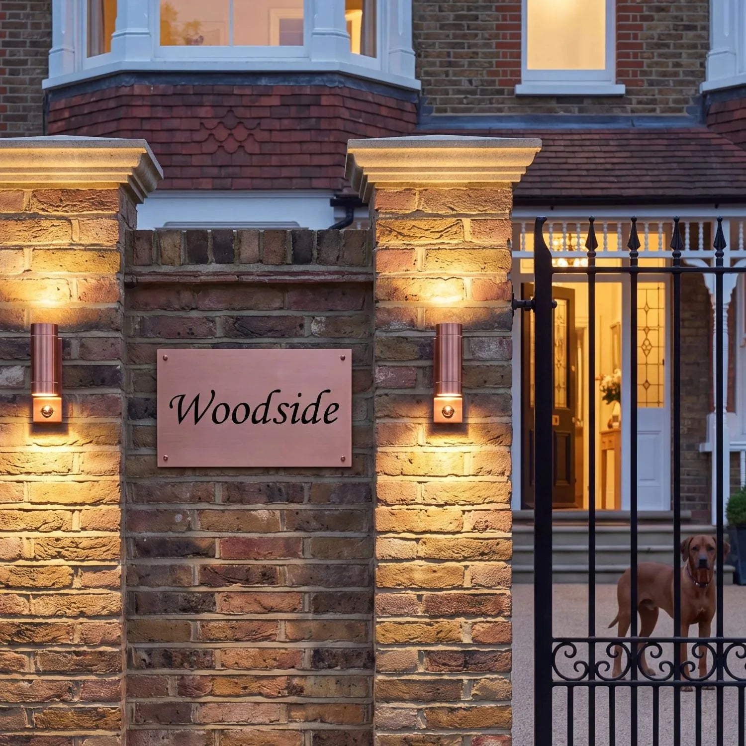 Brushed Copper Outdoor Up & Down PIR Motion Sensor Wall Light Illuminating an Exterior Wall with Dual Up and Down Light Beams | Click Style
