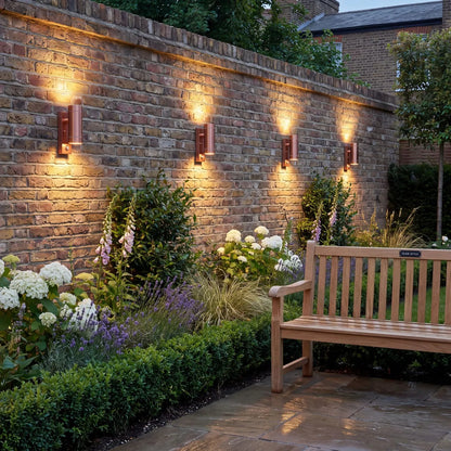 Brushed Copper Outdoor Up & Down PIR Motion Sensor Wall Light Illuminating an Exterior Wall with Dual Up and Down Light Beams | Click Style