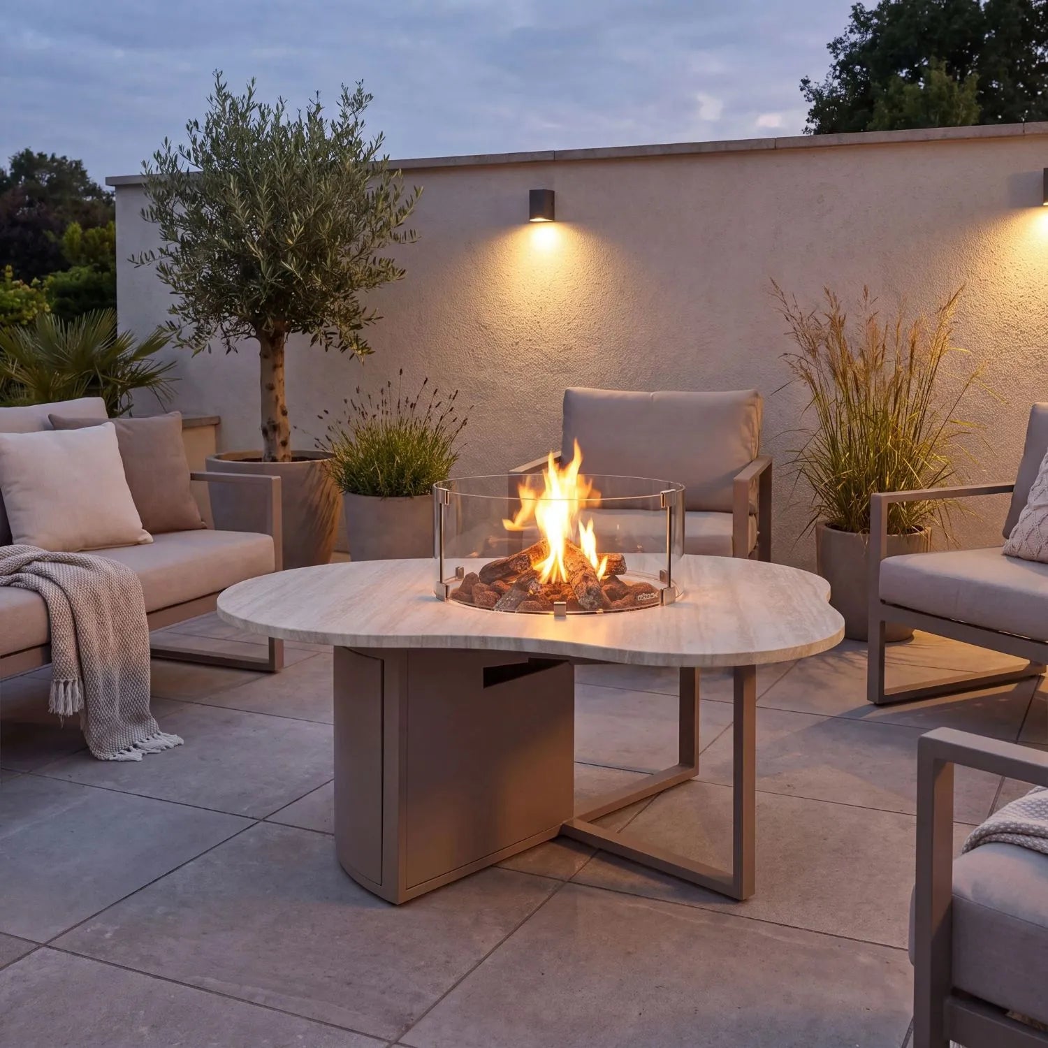Cosiloft Novi Taupe Beige Organic Shaped Aluminium Outdoor Gas Fire Pit Table with Stone Look Top and Glass Wind Guard styled in a contemporary garden 47x120x90cm | Click Style