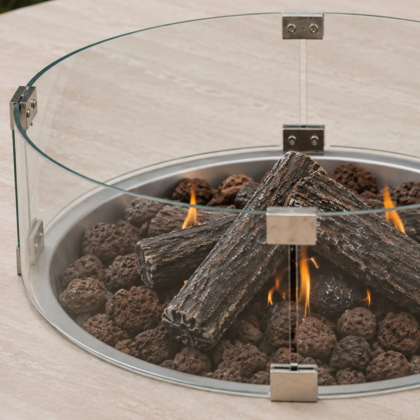 Cosiloft Novi Taupe Beige Outdoor Gas Fire Pit Coffee Table left side close up with Cosiglass Round Wind Guard, ceramic logs and lava stones | Click Style
