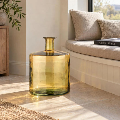 Large Amber Yellow Recycled Glass Bottle Vase with Narrow Neck – Wide Decorative Floor Vase 45x35x35cm – Displayed Empty Beside a Curved Window Seat | Click Style