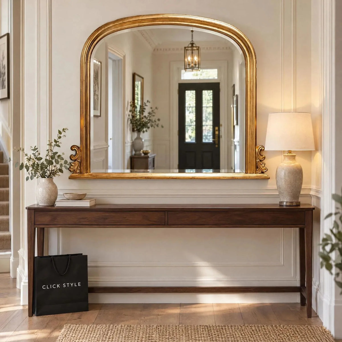 Large Antique Gold Overmantel Mirror with Arched Top & Ornate Scrollwork – Bevelled Glass Gold Leaf Effect Mantle Mirror 94x118x6cm displayed above a dark walnut console table in an elegant British hallway with ivory wall panelling, cream table lamp and decorative foliage | Click Style