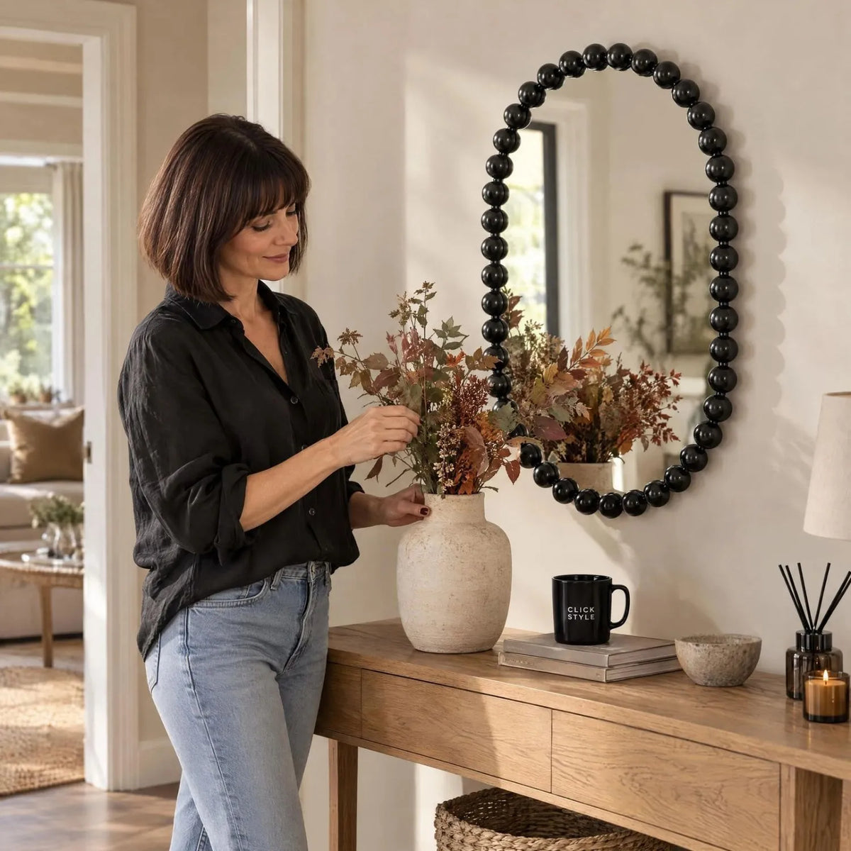 Large Black Bobbin Wall Mirror with Raised Bobbin Frame – Oval Racetrack Pill Shaped Decorative Mirror 90x60x5cm – Woman Styling Autumnal Foliage on Natural Oak Console Table | Click Style