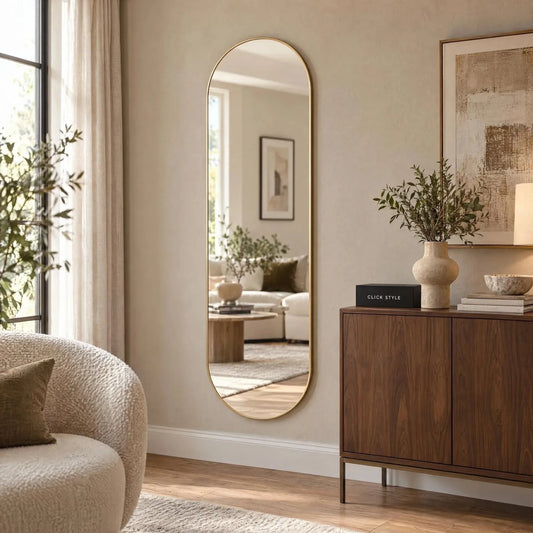 Large Champagne Gold Racetrack Oval Wall Mirror with Slim Metal Frame – Full Length Pill Shaped Mirror 150x50x4cm displayed in a contemporary living room beside a walnut sideboard and cream bouclé chair | Click Style
