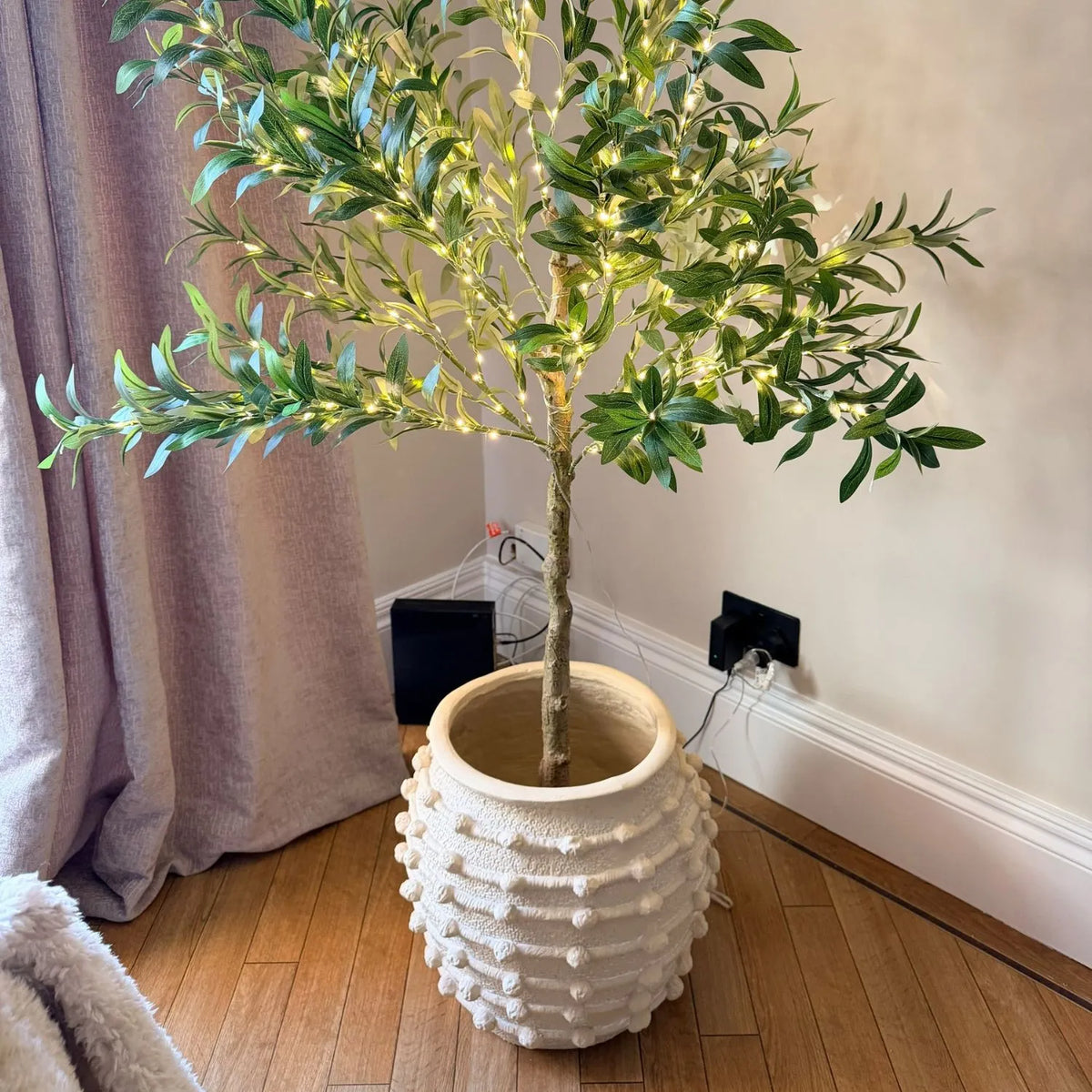 Large Cream Bobbled Fibrestone Planter with Rolled Rim & Raised Textured Detail – Decorative Indoor Plant Pot 39x42x42cm styled with an illuminated artificial olive tree in a customer's home | Click Style