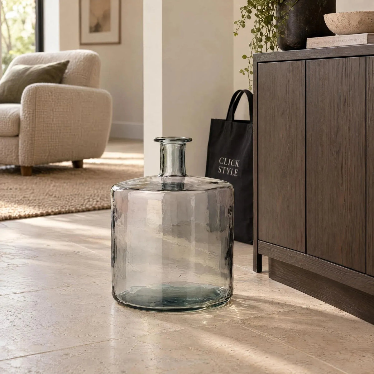 Large Grey Recycled Glass Bottle Vase with Narrow Neck – Wide Decorative Floor Vase 45x35x35cm – Displayed Empty Beside a Dark Wood Sideboard in a Neutral Living Room | Click Style