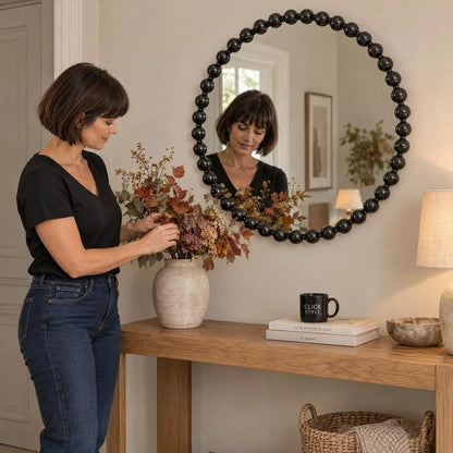 Large Round Black Bobbin Wall Mirror with Raised Bobbin Frame – 80cm Decorative Statement Mirror 80x80x5cm – Woman Styling Autumnal Foliage on Natural Oak Console Table | Click Style