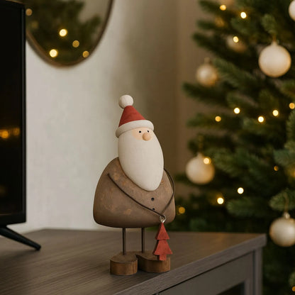 Two rustic wooden & metal Father Christmas ornaments with red hats and tree gifts styled in a modern UK Christmas home | Click Style