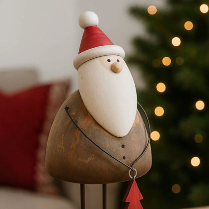 Two rustic wooden & metal Father Christmas ornaments with red hats and tree gifts styled in a modern UK Christmas home | Click Style