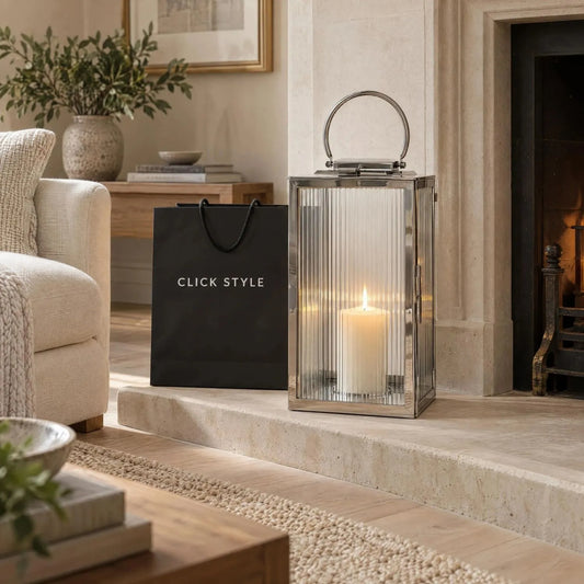 Large Silver Candle Lantern with Shiny Nickel Finish & Ribbed Glass Panels – Decorative Stainless Steel Lantern with Curved Carry Handle 58x30x31cm styled with a lit ivory candle on a limestone fireplace hearth | Click Style