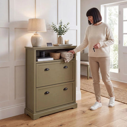 Olive Green Pine Wood 2 Drawer Shoe Storage Unit with Matt Black Cup Handles styled in a modern country hallway with a woman organising the open shelf table lamp vase and home accessories 106x80x28cm | Click Style