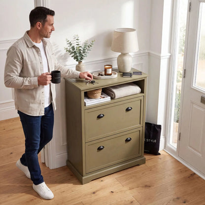 Olive Green Pine Wood 2 Drawer Shoe Storage Unit with Matt Black Cup Handles styled in a modern country hallway with a man holding a Click Style mug beside the cabinet 106x80x28cm | Click Style