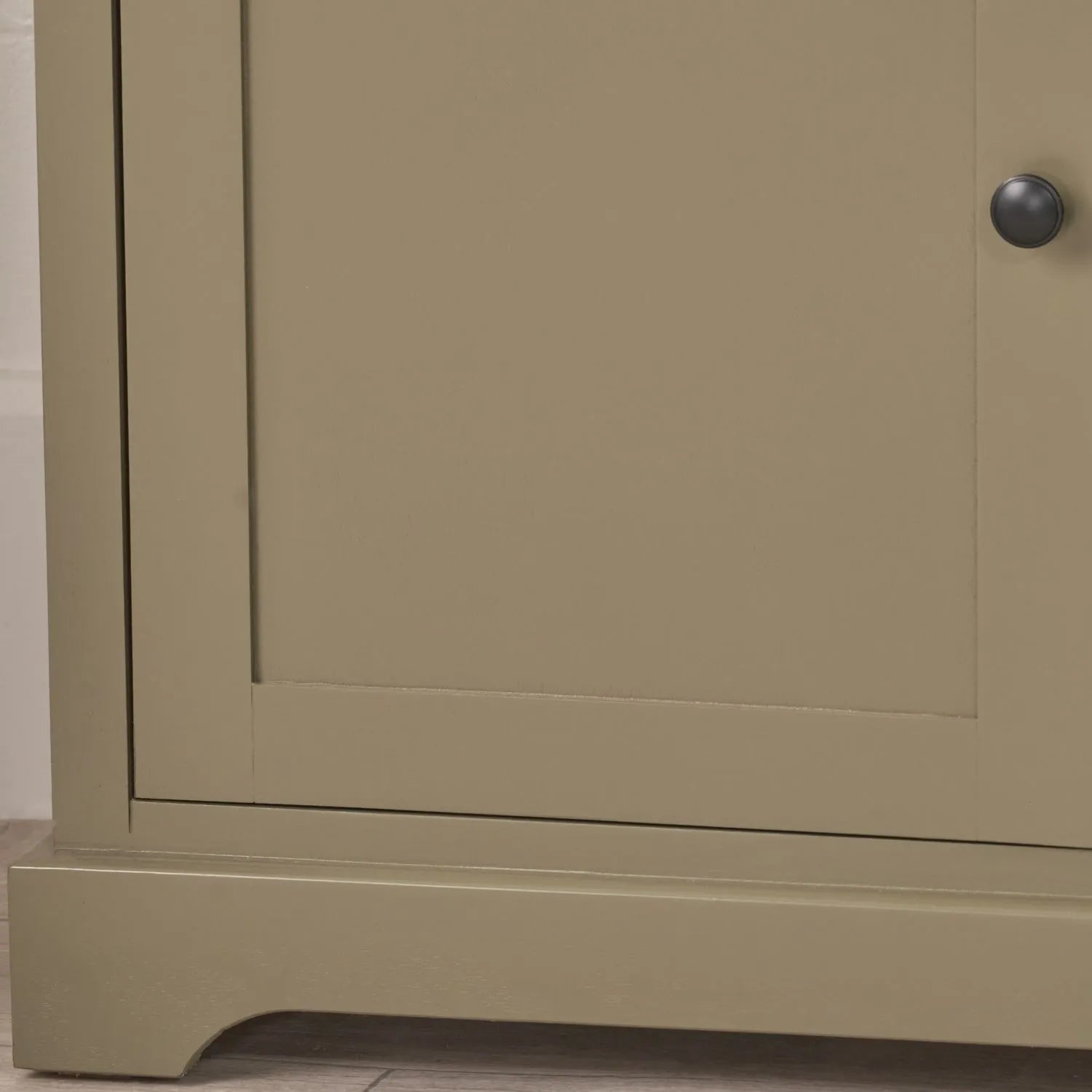 Olive Green Pine Wood 3 Door 3 Drawer Sideboard with Matt Black Cup Handles close up of bottom left corner with black knob handle and plinth base 75x120x35cm | Click Style