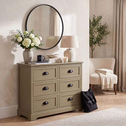 Olive Green Pine Wood 6 Drawer Chest of Drawers with Matt Black Cup Handles Styled in a Modern Country Living Room with Round Wall Mirror Table Lamp Flowers and Decorative Accessories | Click Style