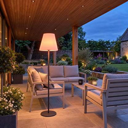 Outdoor Grey Rechargeable LED Floor Lamp with Dimmable & Colour-Changing Settings – Weather-Resistant Garden Light 153x35x35cm glowing warm peach in a covered outdoor lounge with pergola at dusk | Click Style