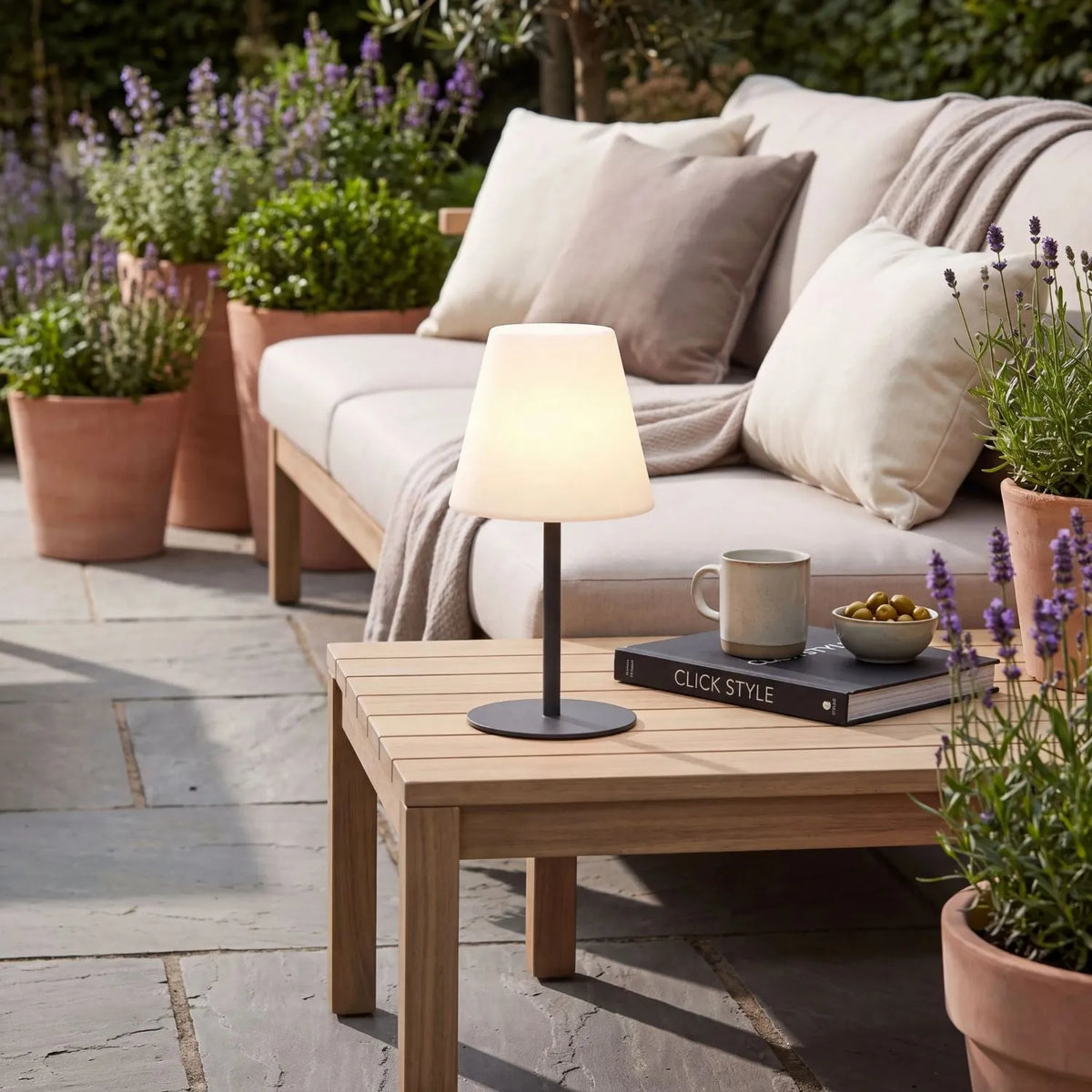 Outdoor Grey Rechargeable LED Table Lamp with Dimmable & Colour-Changing Settings – Weather-Resistant Garden Light 50x24x24cm on an outdoor side table in a lavender garden setting in warm white light mode | Click Style