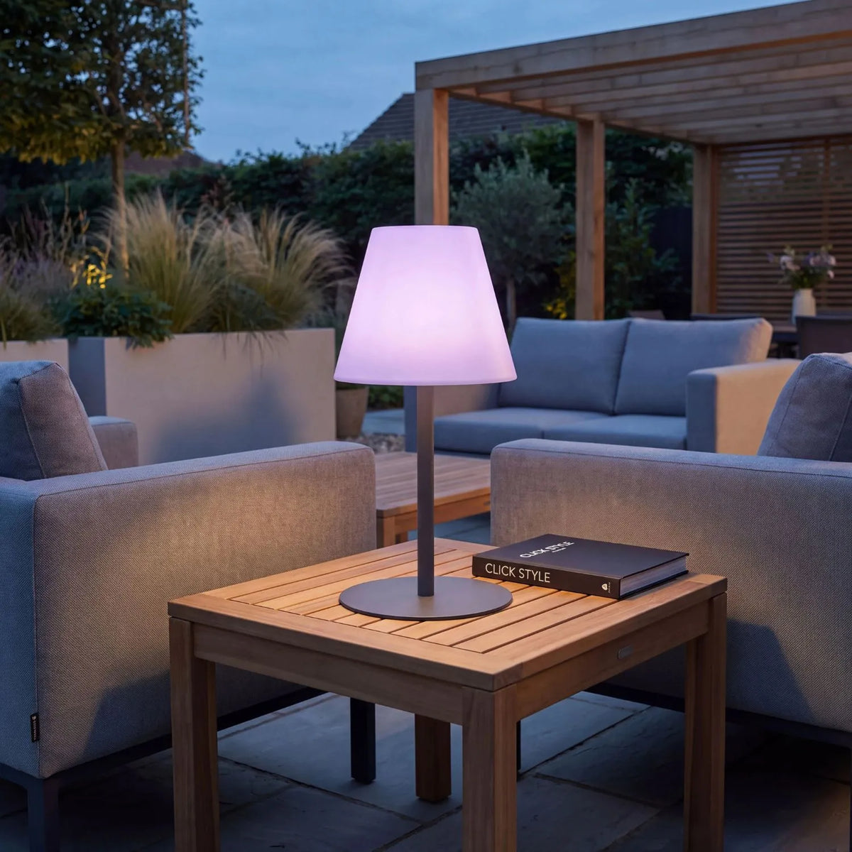 Outdoor Grey Rechargeable LED Table Lamp with Dimmable & Colour-Changing Settings – Weather-Resistant Garden Light 50x24x24cm in a garden lounge setting in lilac light mode | Click Style