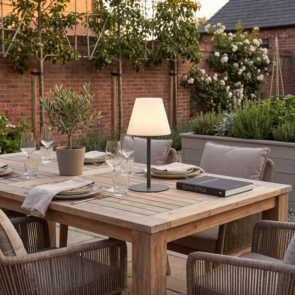 Outdoor Grey Rechargeable LED Table Lamp with Dimmable & Colour-Changing Settings – Weather-Resistant Garden Light 50x24x24cm on an outdoor dining table in warm white light mode | Click Style