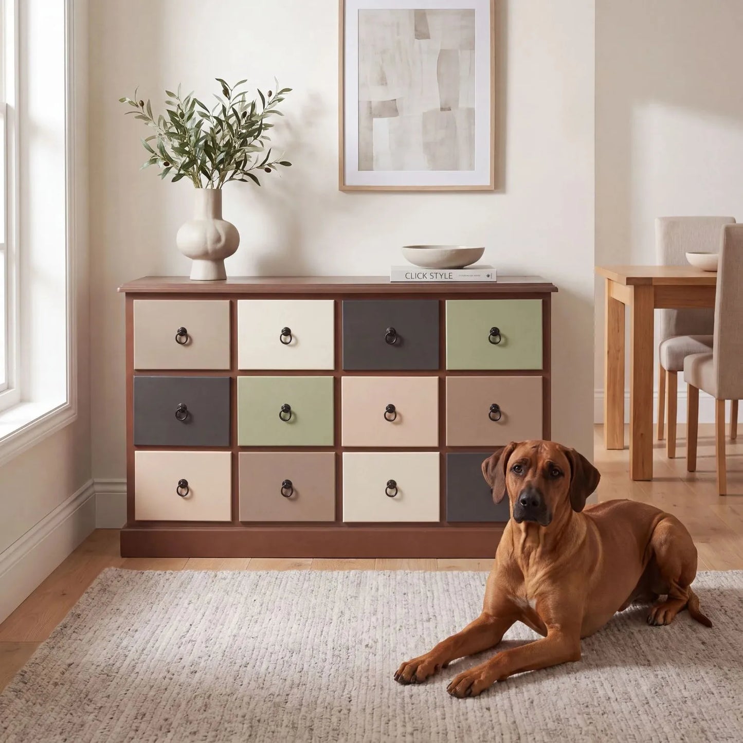 Sage Green & Neutral Pine Wood 12 Drawer Storage Chest with Black Ring Handles styled in a contemporary dining room with Rhodesian Ridgeback | Click Style